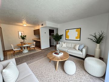 Baytown apartment for rent - A living room with a white couch, a wooden coffee table, and a painting on the wall.
