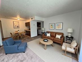 Mt. Vernon apartment for rent - A living room with a blue couch, a wooden coffee table, and a lamp.