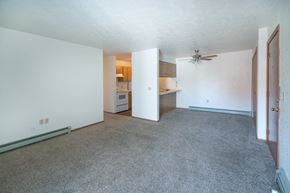 Lexington apartment for rent - an empty living room and kitchen with a ceiling fan