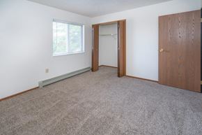 Lexington apartment for rent - a bedroom with carpet and a door to a closet