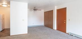 Ubly apartment for rent - an empty room with a ceiling fan and two doors