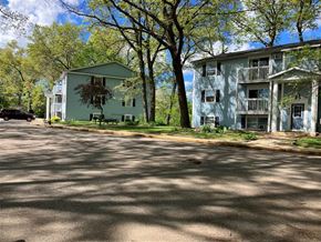 Paw Paw apartment for rent - two houses on the side of a street with trees