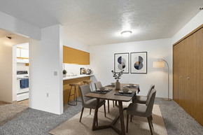 Cullman apartment for rent - A dining room with a table set for two and a kitchen area in the background.
