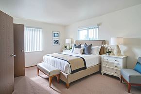 Hopkinsville apartment for rent - A bedroom with a bed, nightstand, and chair.