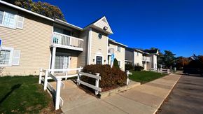 Lapeer apartment for rent - an apartment building with a wooden bench in front of it