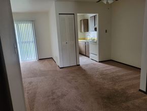 Ionia apartment for rent - an empty living room with a door to a kitchen