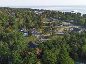 Port Sanilac apartment for rent - an aerial view of a neighborhood with trees and a body of water