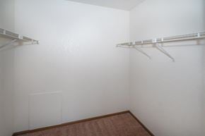 Sebewaing apartment for rent - a white closet with two hanging racks on the wall