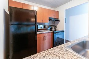 Howell apartment for rent - a kitchen with black appliances and granite counter tops