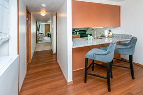 East Lansing apartment for rent - Fitted Kitchen With Island Dining at Raleigh House Apartments, MRD Apartments, East Lansing, Michigan