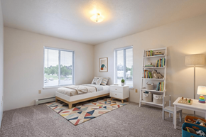 Sturgis apartment for rent - A bedroom with a bed, nightstand, and bookshelf.