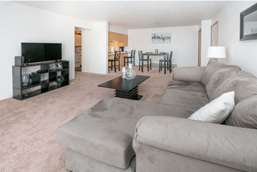 Fenton apartment for rent - A living room with a grey couch and a black coffee table.
