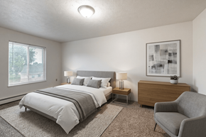 Hillsdale apartment for rent - A bedroom with a large bed and a chair.
