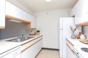 Decatur apartment for rent - A kitchen with white cabinets and a white refrigerator.