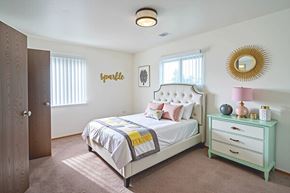 Grandview Plaza apartment for rent - A bedroom with a bed, nightstand, and a mirror on the wall.