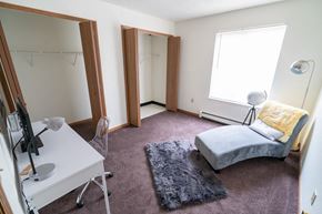Lebanon apartment for rent - a bedroom with a bed and a desk and a mirror