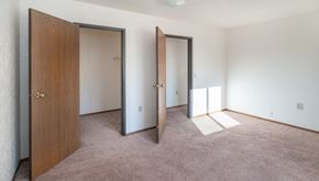 Gagetown apartment for rent - an empty bedroom with three doors and carpeting