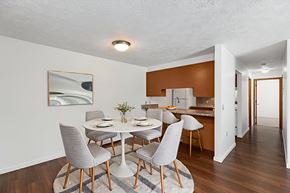Howell apartment for rent - A dining room with a white table and grey chairs.