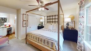 Smyrna apartment for rent - A bedroom with a four poster bed and a dresser.