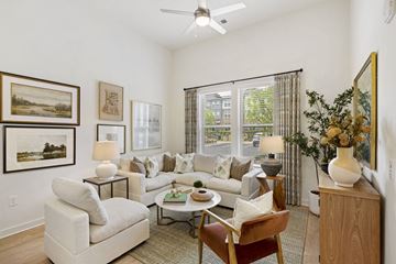Norcross apartment for rent - A living room with a white couch, a coffee table, and a painting on the wall.