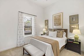 Norcross apartment for rent - A bedroom with a large bed and a window with curtains.