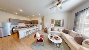 Norcross apartment for rent - A modern living room with a white sofa and a wooden coffee table.