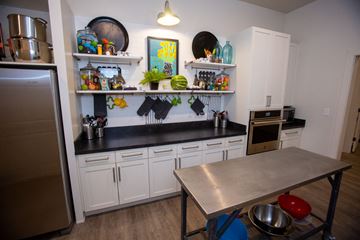 Austell apartment for rent - A kitchen with a table and a fridge.