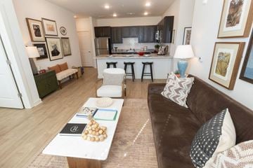 Villa Rica apartment for rent - A brown couch sits in a living room with a coffee table in front of it.