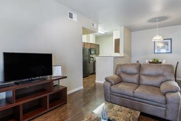 Midland apartment for rent - A living room with a grey couch and a black television.