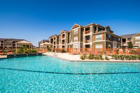 Odessa apartment for rent - A large building with a pool in front of it.