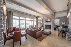 Odessa apartment for rent - A living room with a stone fireplace and a flat screen TV mounted above it.