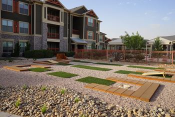 Outdoor game court with corn hole, horseshoe, and washer game set