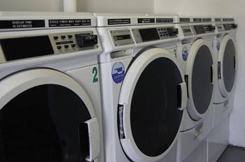 A row of washing machines in a public laundromat