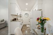 Ridge apartment for rent - a view of beautiful white kitchen and dining room area at Brookwood at Ridge, New York, 11961