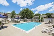 Ridge apartment for rent - view of our sparkling swimming pool with chairs and umbrellas at Brookwood at Ridge, New York, 11961