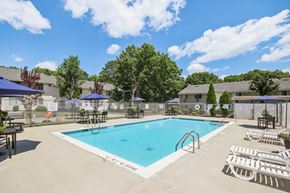 Ridge apartment for rent - view of our sparkling swimming pool with chairs and umbrellas at Brookwood at Ridge, New York, 11961