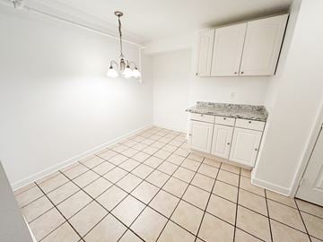 Nashville apartment for rent - A kitchen with white cabinets and a marble countertop.