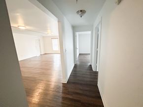 Nashville apartment for rent - A long hallway with wood floors and white walls.