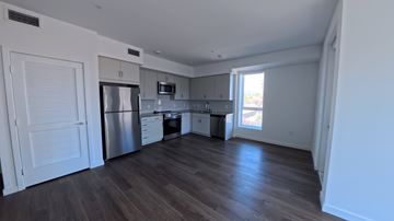 Northridge apartment for rent - A kitchen with white cabinets and a stainless steel refrigerator.