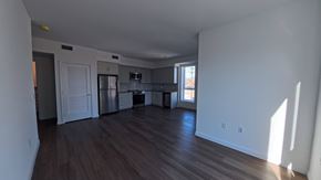 Northridge apartment for rent - A large empty room with wooden floors and white walls.