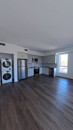 Northridge apartment for rent - A spacious kitchen with dark wood flooring and modern appliances.