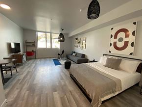 Los Angeles apartment for rent - a bedroom with a bed and a couch and a tv