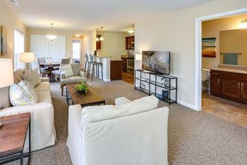 Fairport apartment for rent - A living room with a white couch and a coffee table.