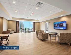 Buffalo apartment for rent - A spacious lounge area with a flat screen TV mounted on the wall.