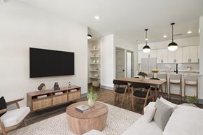 Austin condo for rent - A modern living room with a flat screen TV mounted on the wall.
