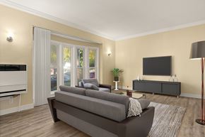Los Angeles apartment for rent - A living room with a grey sofa and a television on the wall.