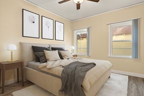 Los Angeles apartment for rent - A bedroom with a bed, a ceiling fan, and three framed pictures on the wall.