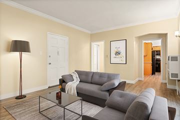 Los Angeles apartment for rent - A living room with a grey couch and a black floor lamp.