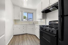Los Angeles apartment for rent - A black stove in a white kitchen with a window.