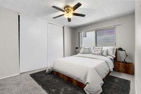 Los Angeles apartment for rent - A bedroom with a bed, a ceiling fan, and a window.